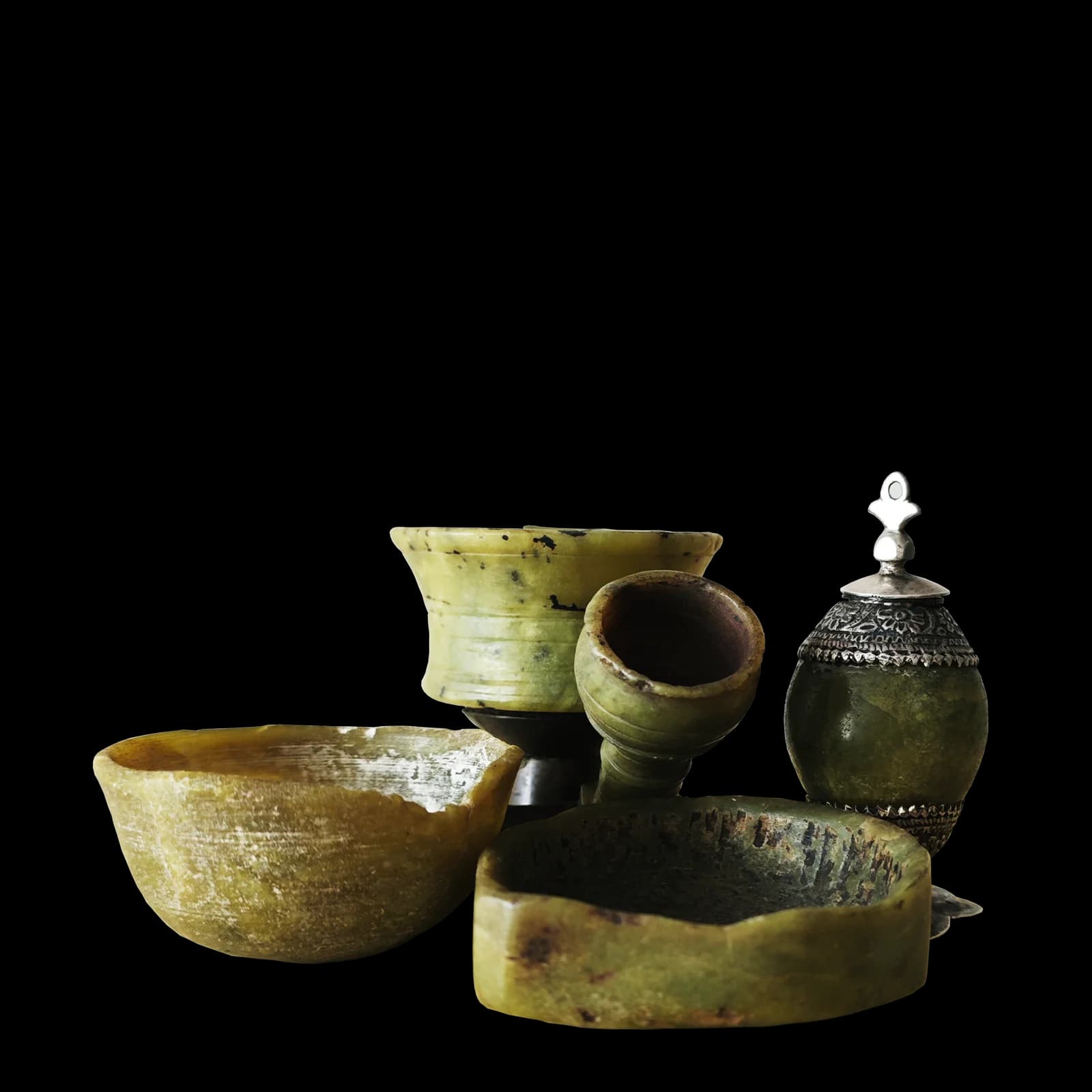 Carved green serpentine stone (zahar mohar) bowls and a silver-mounted jar